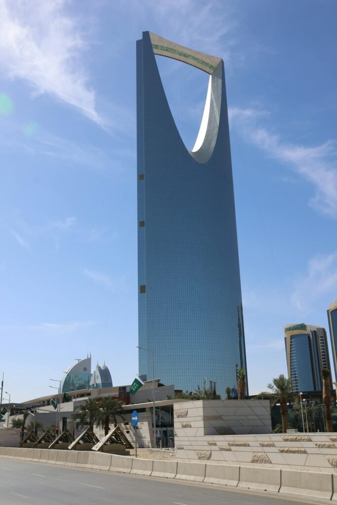 The iconic Kingdom Centre Tower in Riyadh — the 302-meter glass-and-steel landmark with its distinctive curved Skybridge observation deck, the visual symbol of modern Saudi Arabia's capital