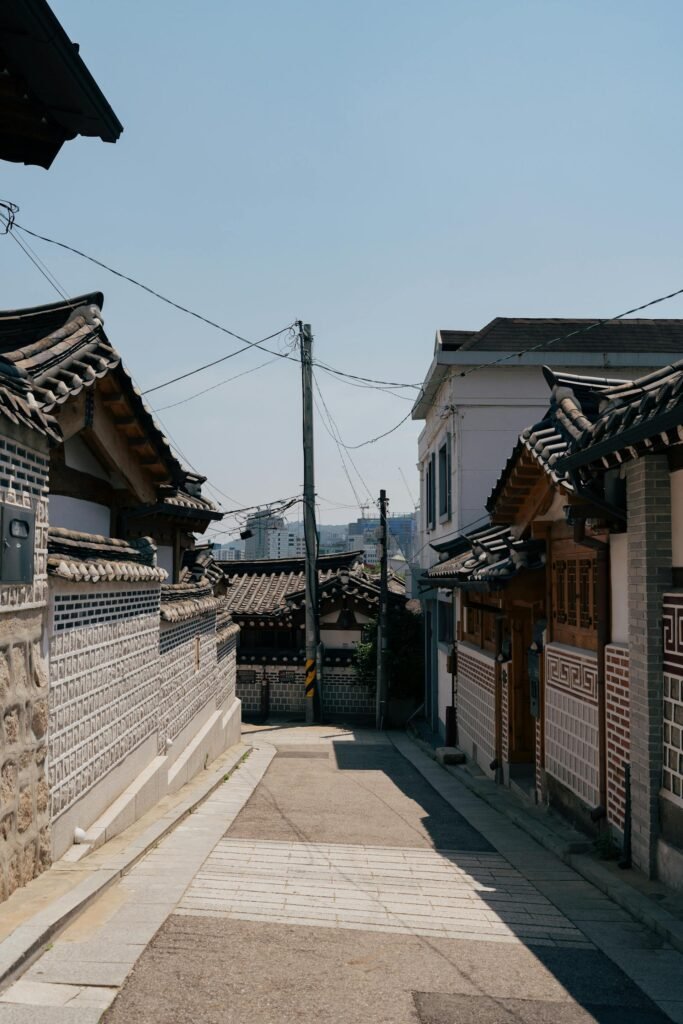 A traditional Korean street in Bukchon Hanok Village, Seoul, featuring centuries-old hanok wooden houses