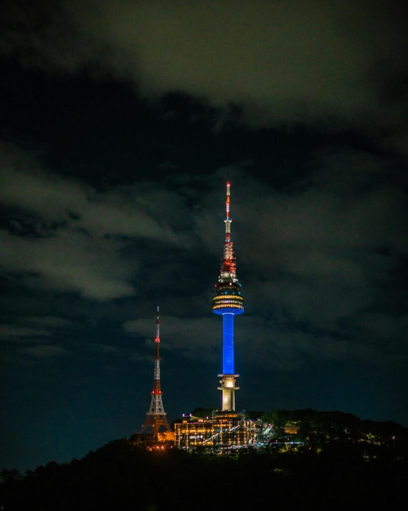 The illuminated N Seoul Tower (Namsan Tower) silhouetted against a dark night sky in Seoul