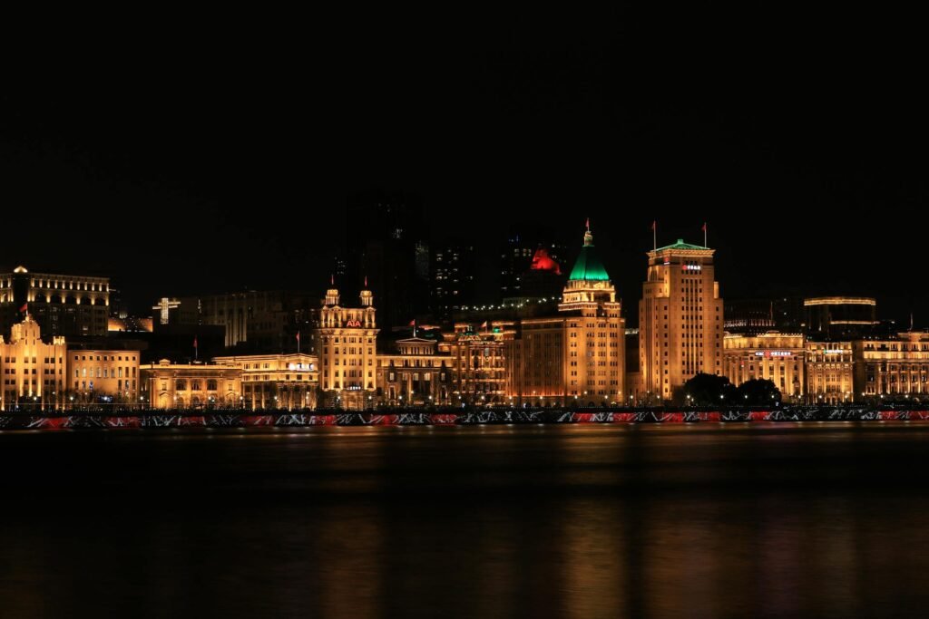 Night view of Shanghai's Bund with illuminated historic colonial-era buildings along the waterfront
