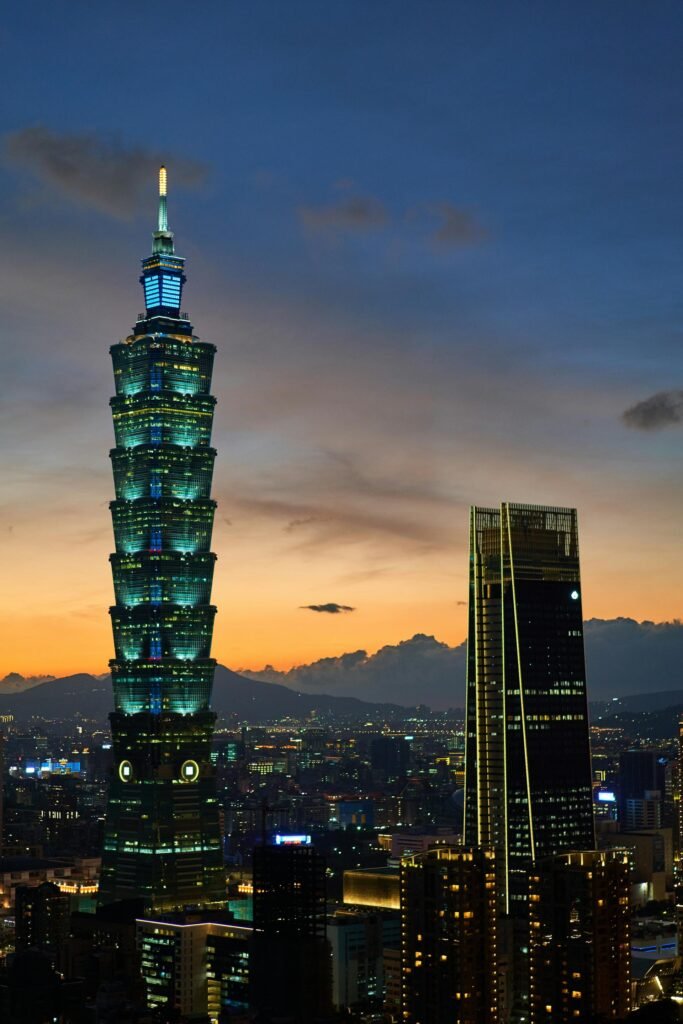 Stunning view of Taipei 101 and the Taipei cityscape at sunset, illuminated against the evening sky