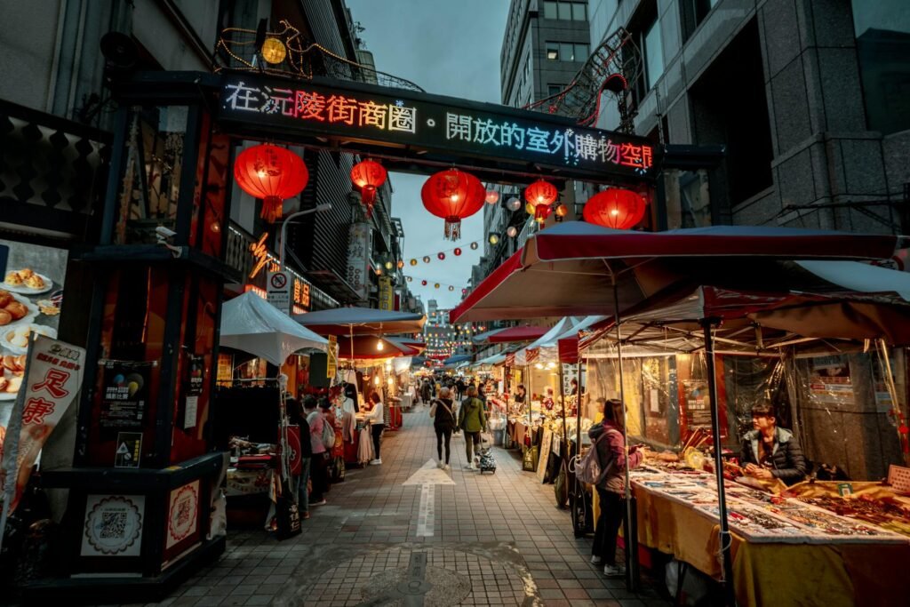Bustling Taipei night market featuring colorful lanterns and diverse food stalls