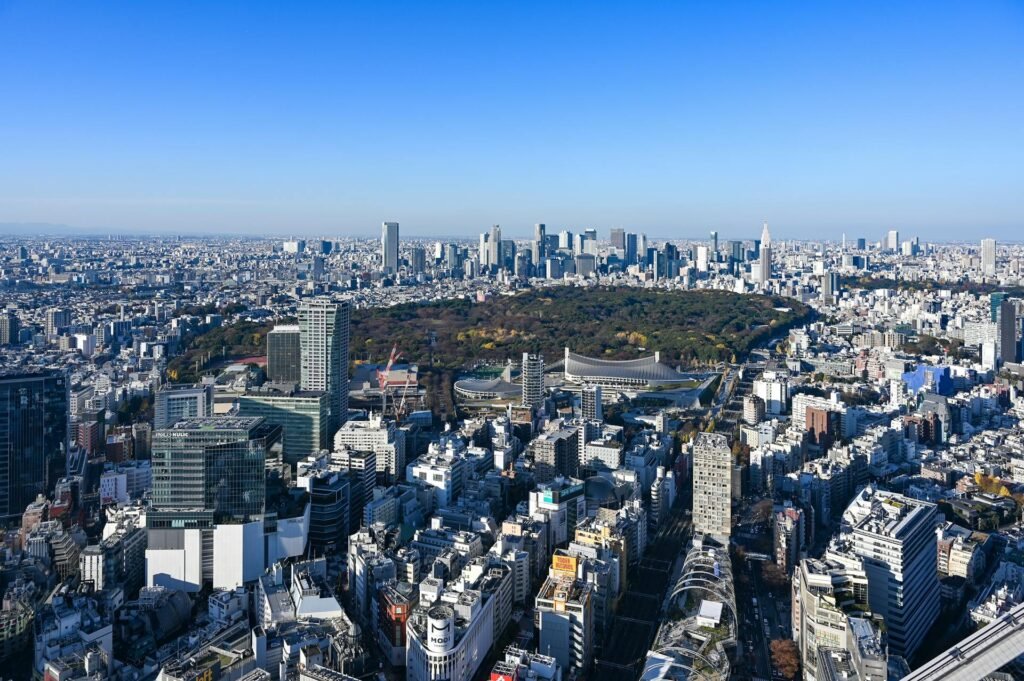 Aerial view of Tokyo cityscape featuring Shinjuku Park surrounded by skyscrapers — central Tokyo's western district