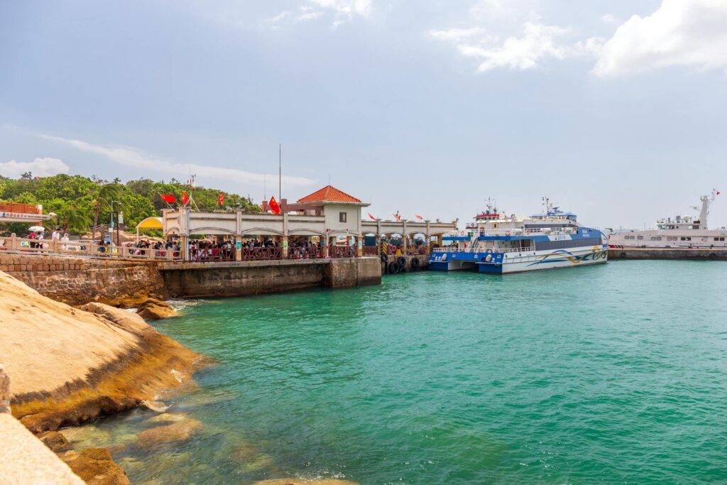 Bustling Zhuhai pier with moored ferries and Chinese flags — the gateway to the Wanshan Archipelago's seafood and island day-trips