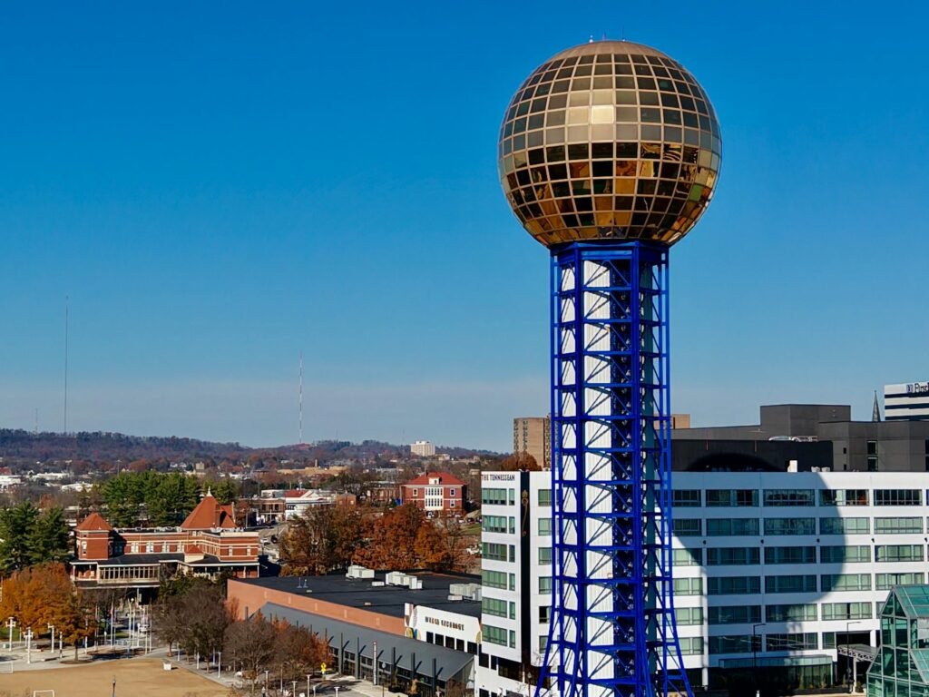 The golden Sunsphere tower on its blue steel lattice at World's Fair Park in Knoxville under a clear sky, the city's iconic 1982 World's Fair landmark