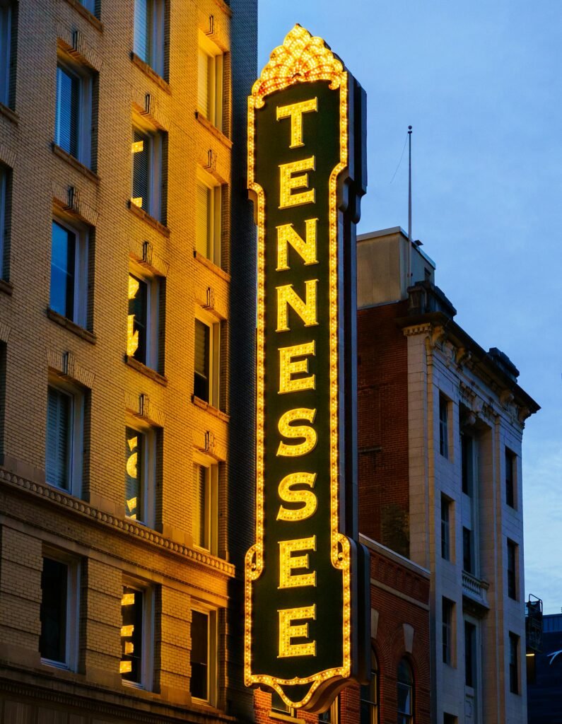 The illuminated Tennessee Theatre marquee in downtown Knoxville at twilight, the 1928 venue that anchors the city's festival and live-events calendar