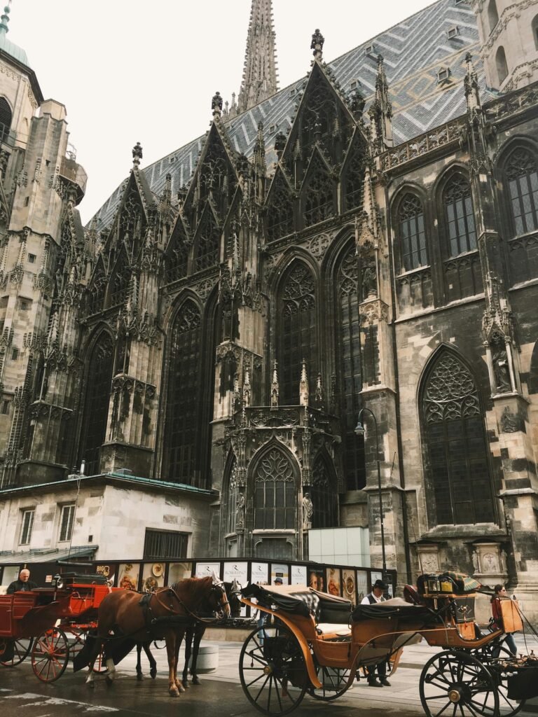 St. Stephen's Cathedral in Vienna with its Gothic facade and horse-drawn Fiaker carriages waiting outside